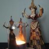 snake goddess statue and candle